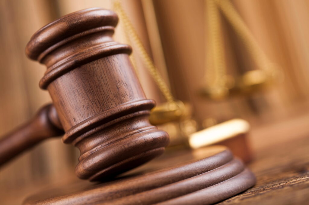 A legal gavel resting on the desk of an attorney's office.